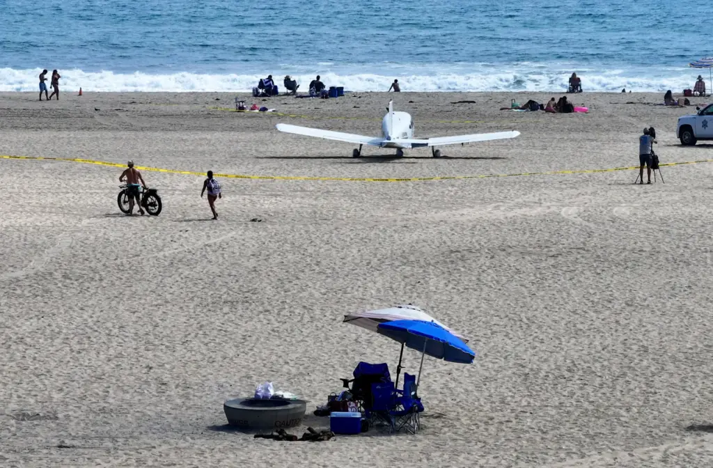A Piper Cherokee 140 sits on the sand after an...