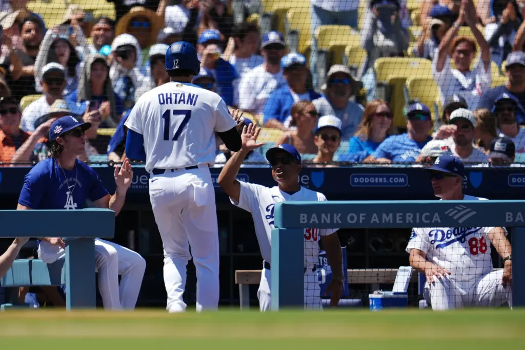 Dodgers’ Shohei Ohtani (17) returns to the dugout after scoring...