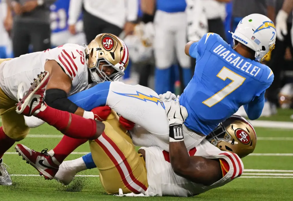 Chargers quarterback DJ Uiagalelei (7) is sacked by San Francisco...