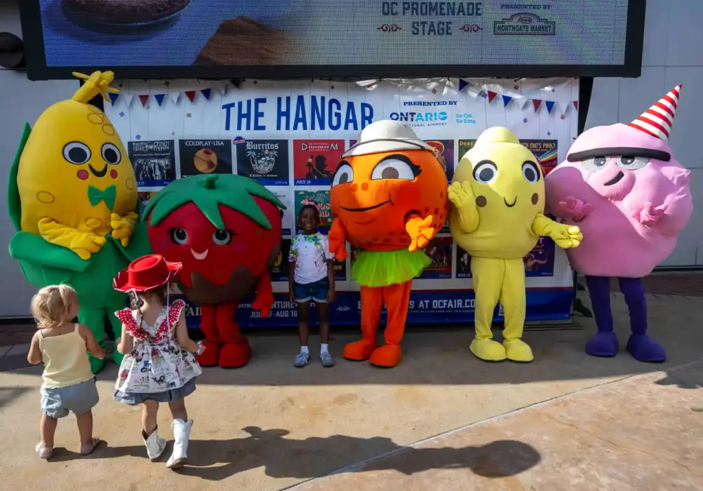 Kids greet the OC Fair mascots, Cornelius Corn, Strawberry Jan,...