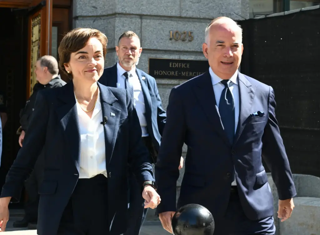 Coalition Avenir Quebec Leader Christine Frechette walks with her spouse, Guy Nadeau.