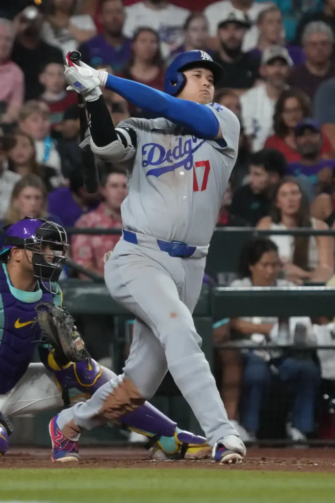 Dodgers star Shohei Ohtani swings at a pitch during a...