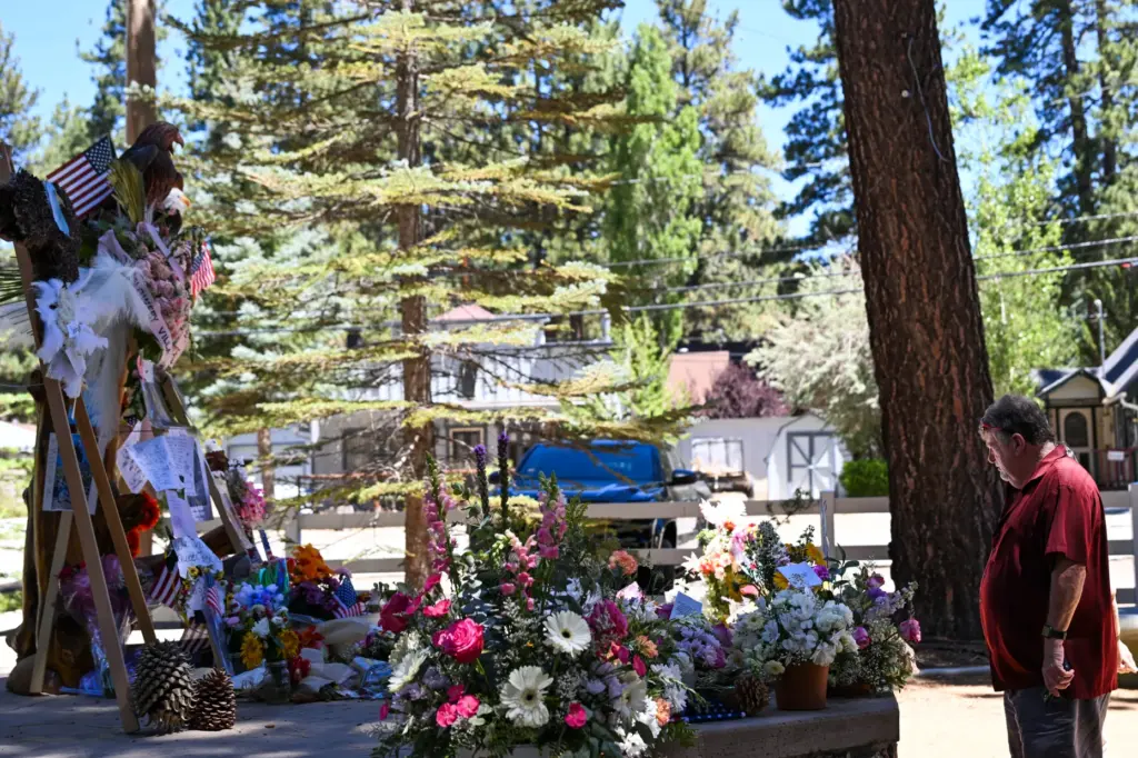 Guests vist the memorial for Jackie, the Big Bear bald...