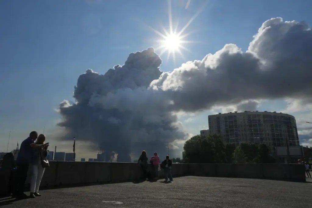 Smoke billows into the sky following Ukrainian drone strikes on Russia's Wildberries.