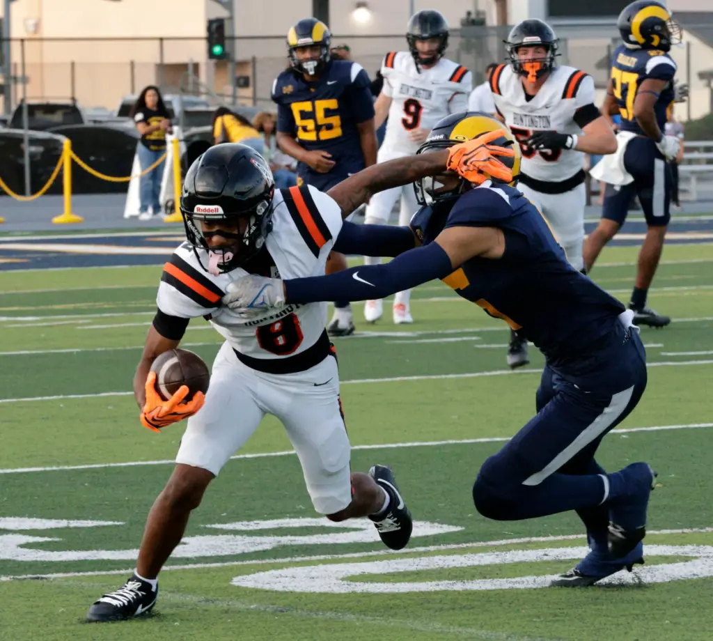 Huntington Beachs Skylar Robinson (8) tries to push off Millikans...