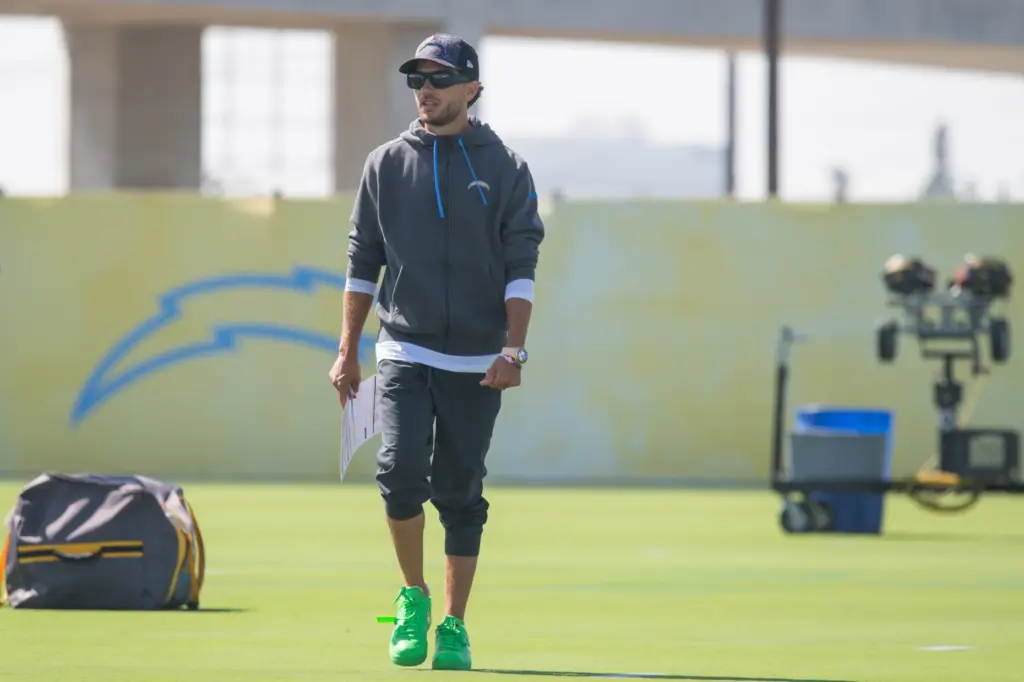 Los Angeles Chargers offensive coordinator Mike McDaniel walks on the...