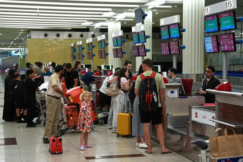 Travelers check in at Terminal 3 of Dubai International Airport...
