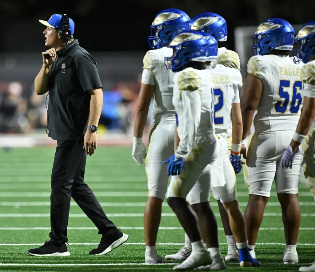 Santa Margarita head coach Carson Palmer quesytions an official against...