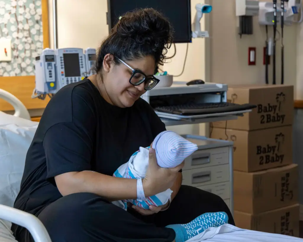 Alicia Salgado holds one of her newborns on Thursday, Aug....