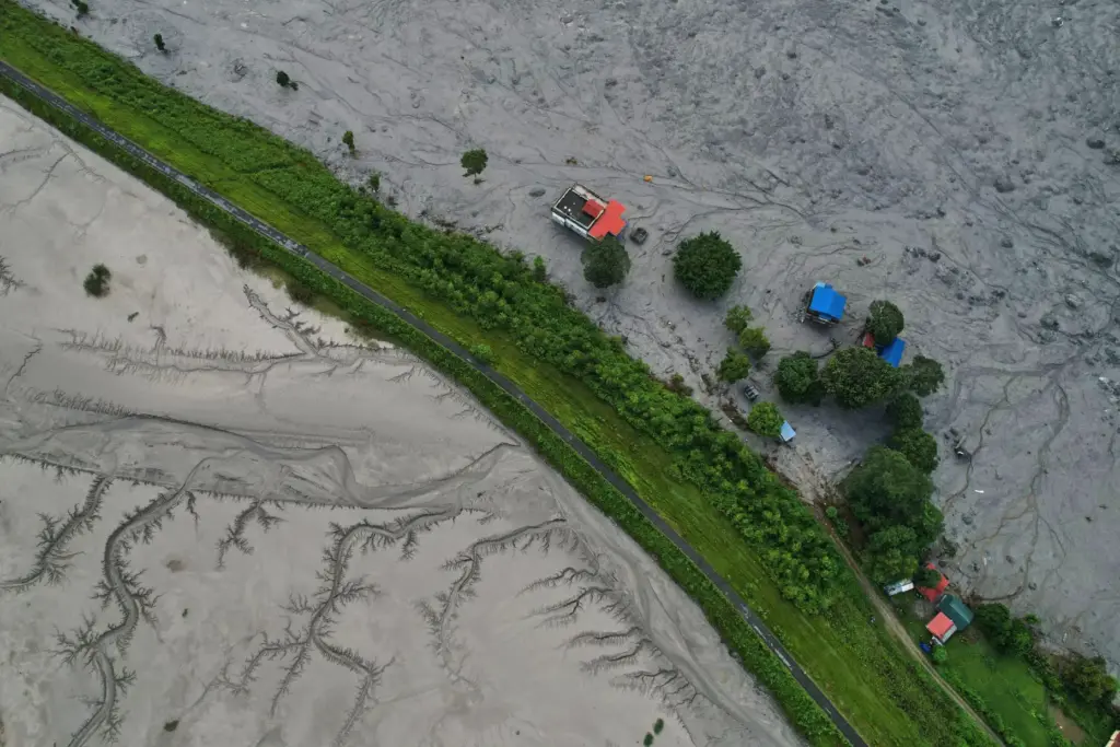 A drone view shows a major section of Pasang Lhamu highway washed away.