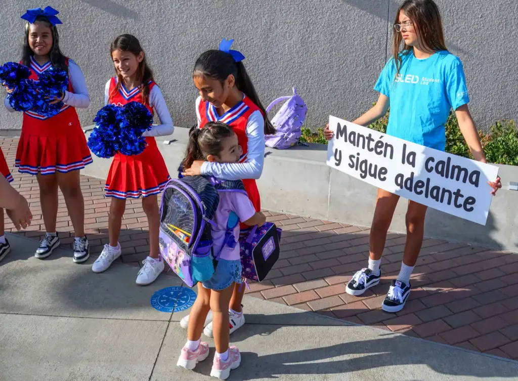 Ava Serna, 5, gets a warm welcome on the first...