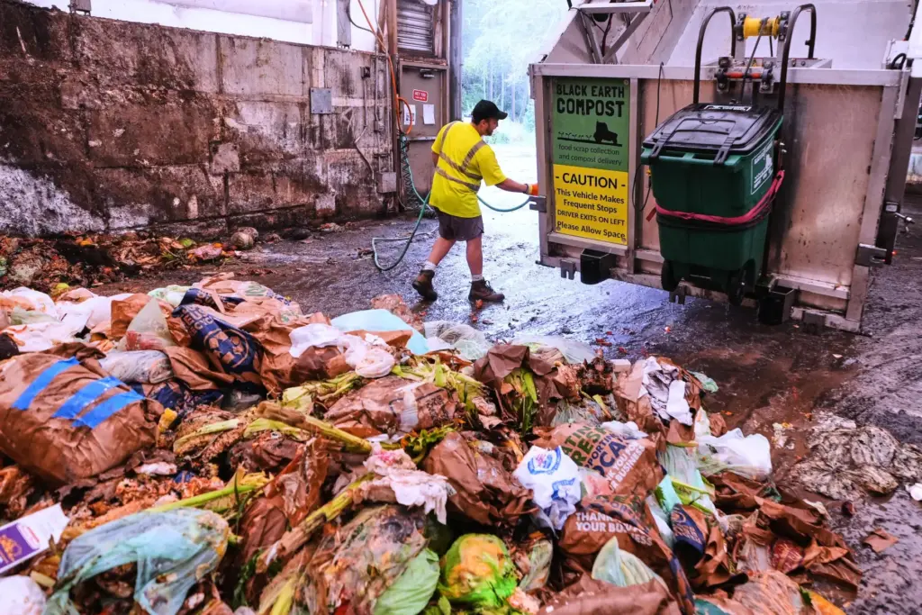 Paul Milonopolous rinses out the dump box after offloading fresh...