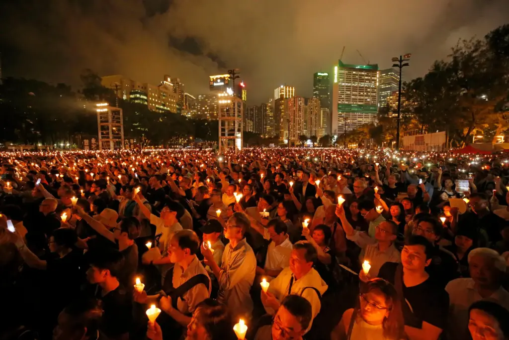 Thousands of people attend a candlelight vigil.
