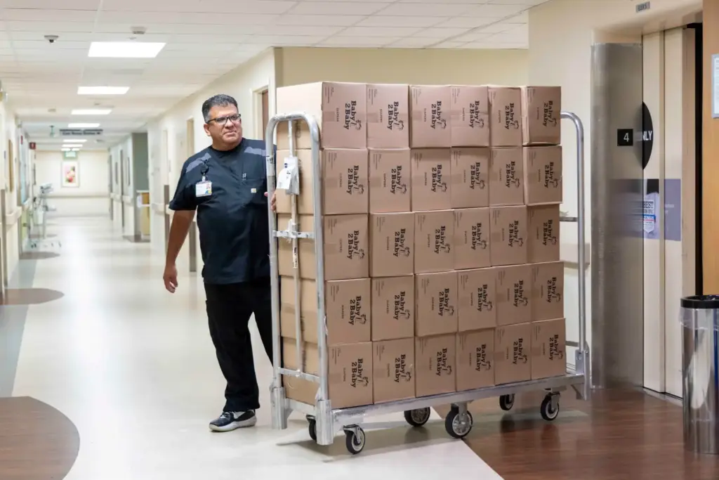 Lead Inventory Clerk David Fonseca pushes a cart of diapers...