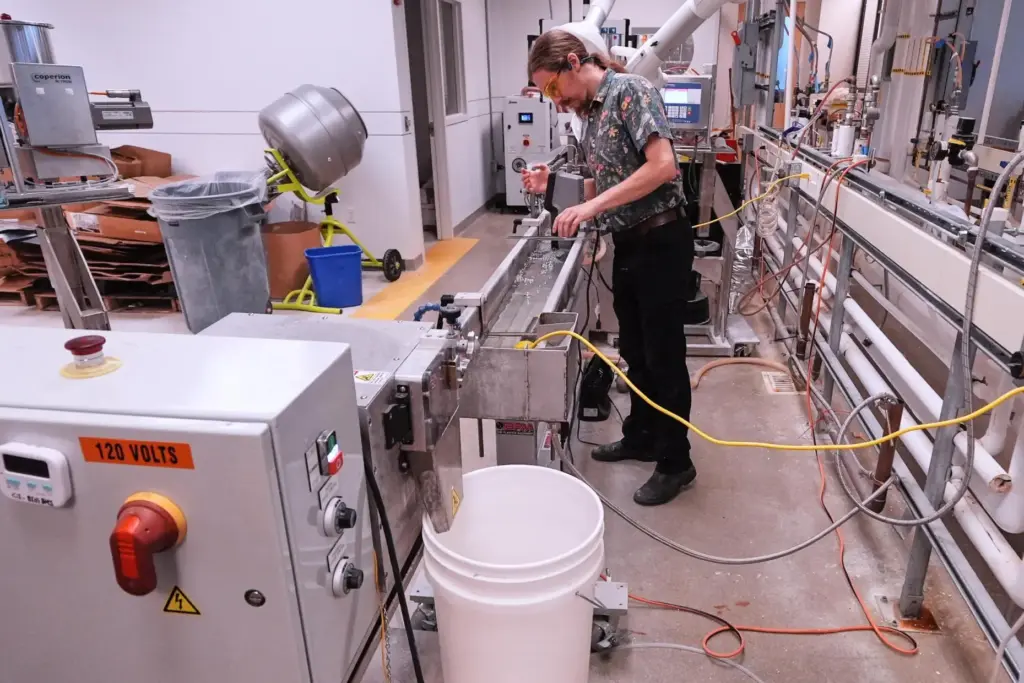 Lab technician Fen Spinney calibrates a machine that is used...