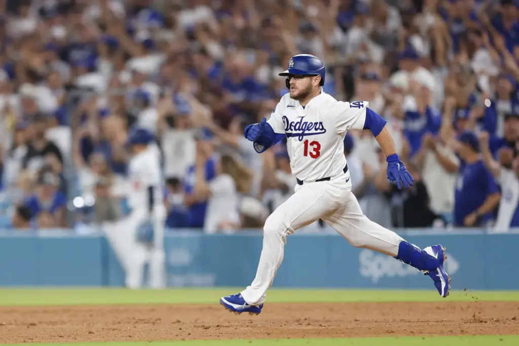 The Dodgers’ Max Muncy rounds first base after hitting a...