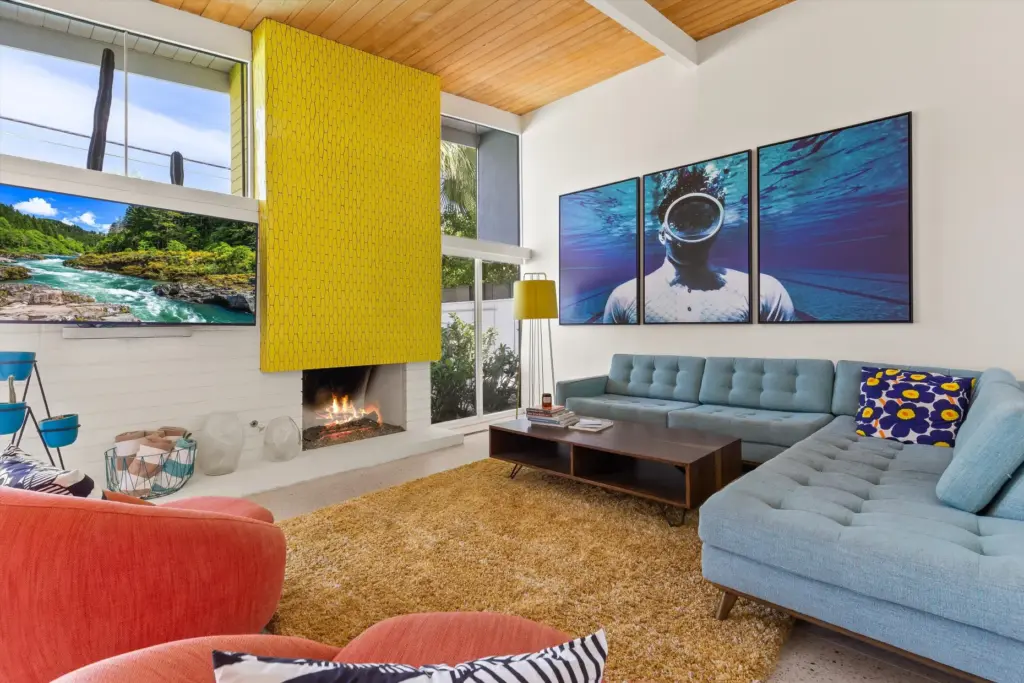 The hooded fireplace, finished in mustard yellow tile. (Photo by...