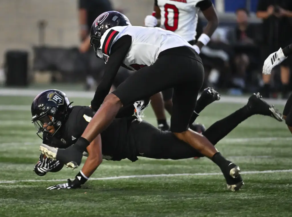 Serviteâs Jorden Wells (4) holds onto the ball as Centennialâs...