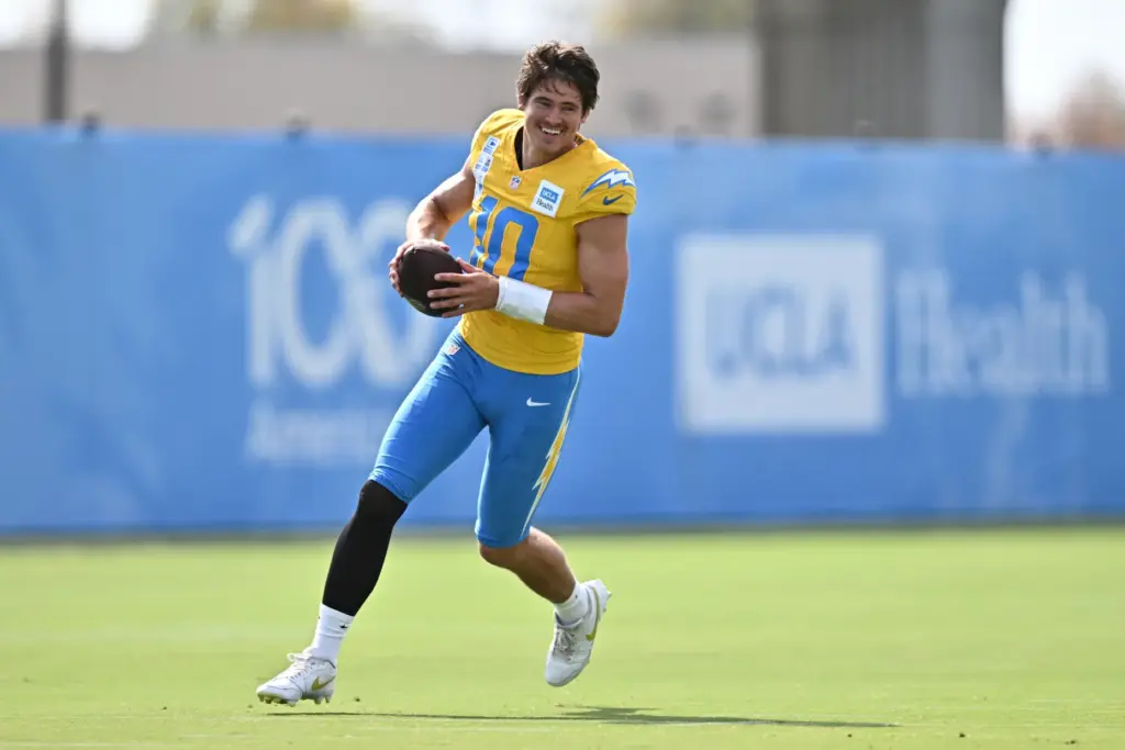 Chargers quarterback Justin Herbert runs a drill during a training...