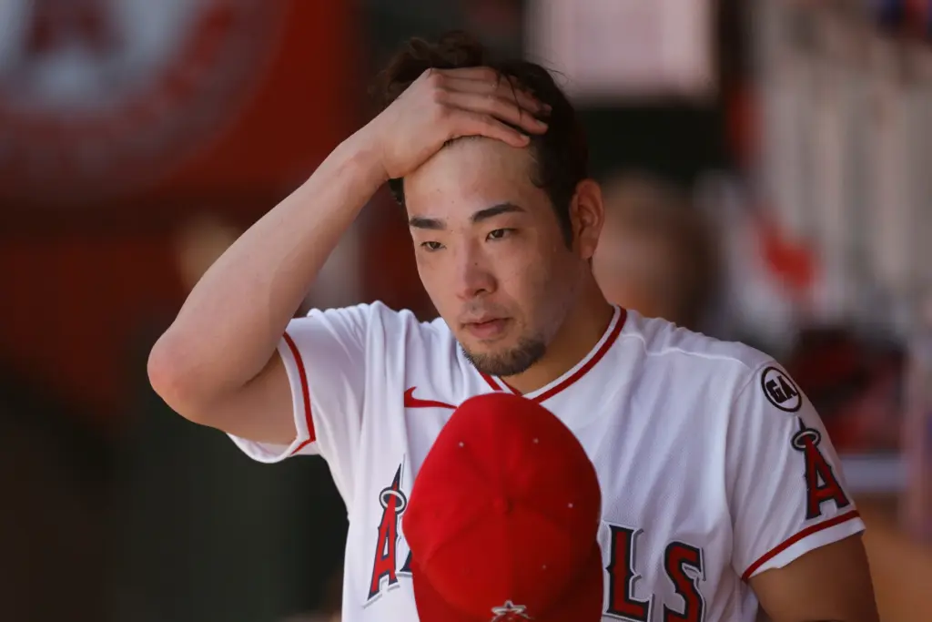 Angels starting pitcher Yusei Kikuchi (16) stands in the dugout...