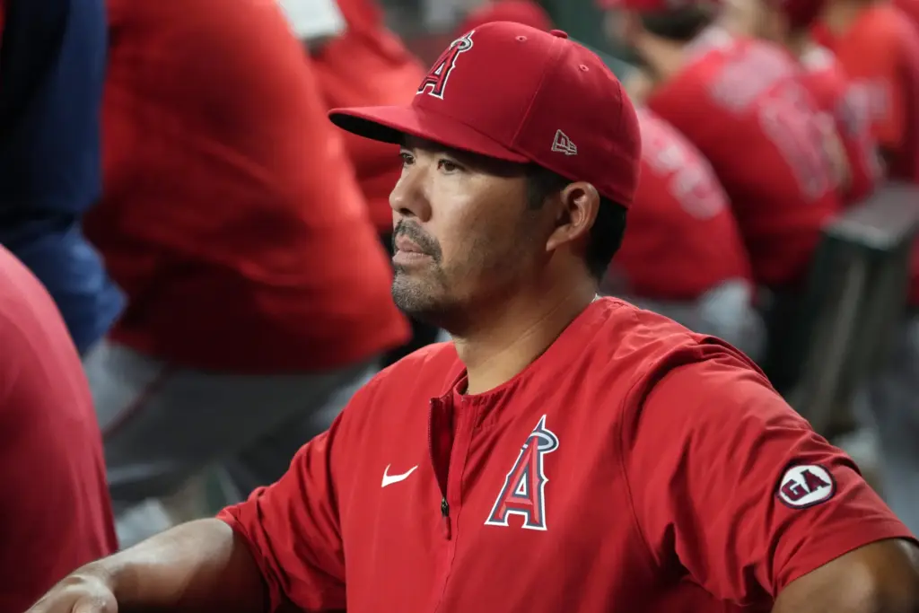 Angels manager Kurt Suzuki looks on from the dugout during...