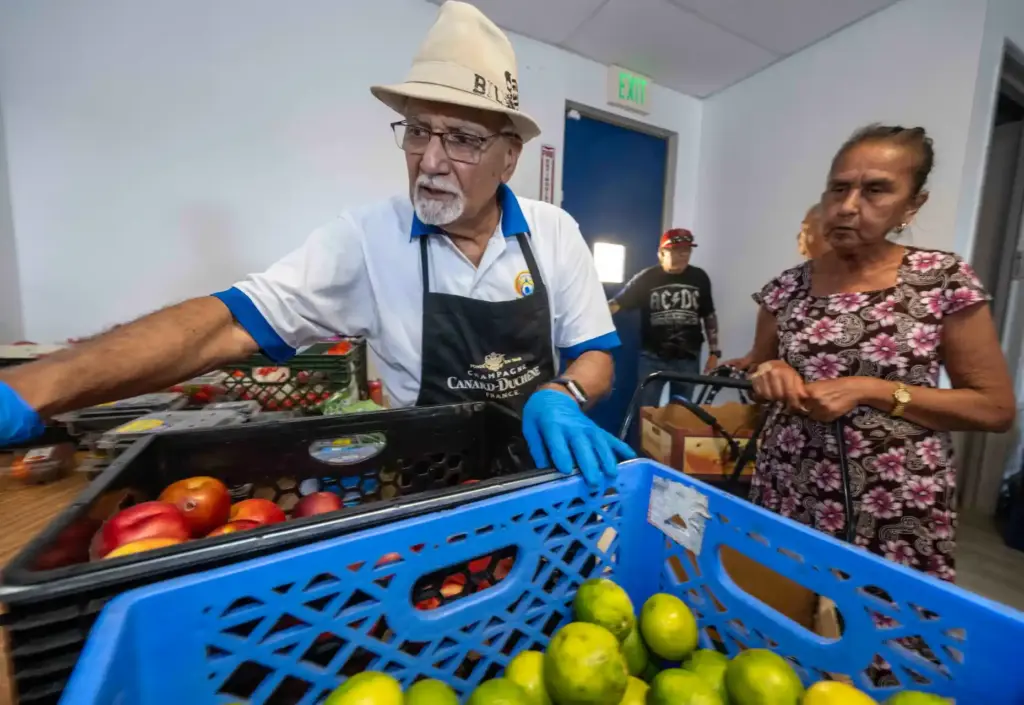 Dave Bhasin, left, a volunteer at the Delhi Center for...