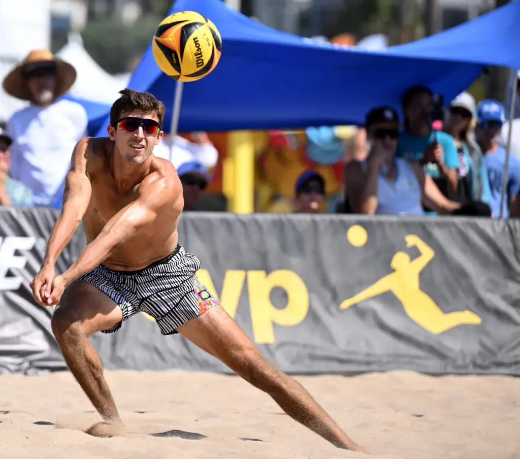Timothy Brewster digs for the ball as he and Ryan...