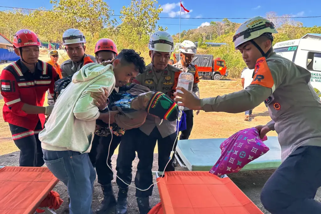 Rescuers evacuate a person injured in an earthquake in North Lamba Leda, Indonesia.