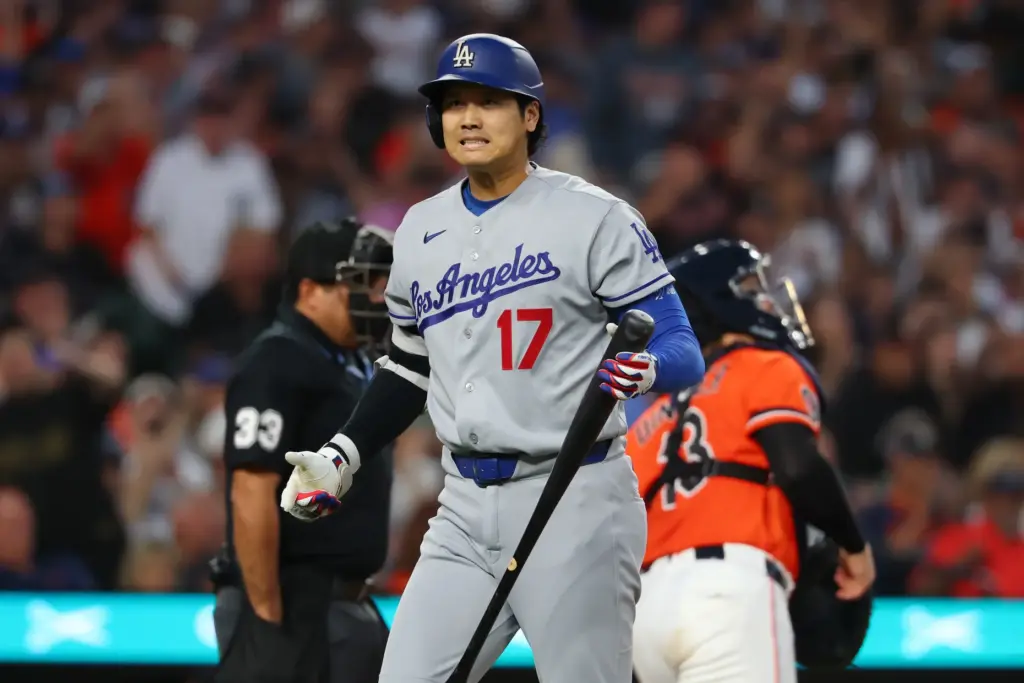Dodgers star Shohei Ohtani reacts after striking out during the...