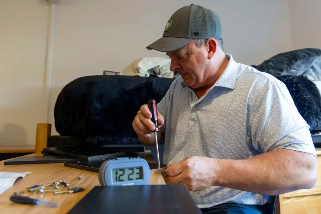 Sean Murphy builds a storage organizer for his son on...