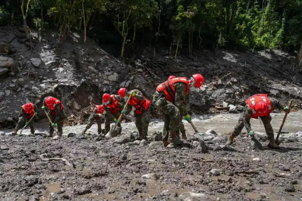 In this photo released by Xinhua News Agency, rescuers from...