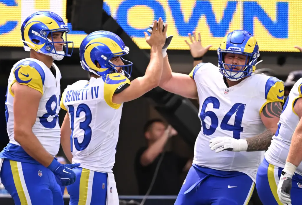 Rams quarterback Stetson Bennett IV (13) high-fives offensive tackle Austin...