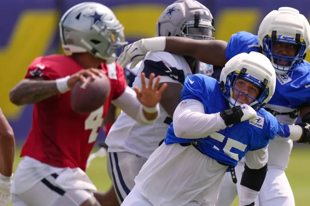 Rams defensive end Braden Fiske, lower right, goes after Dallas...