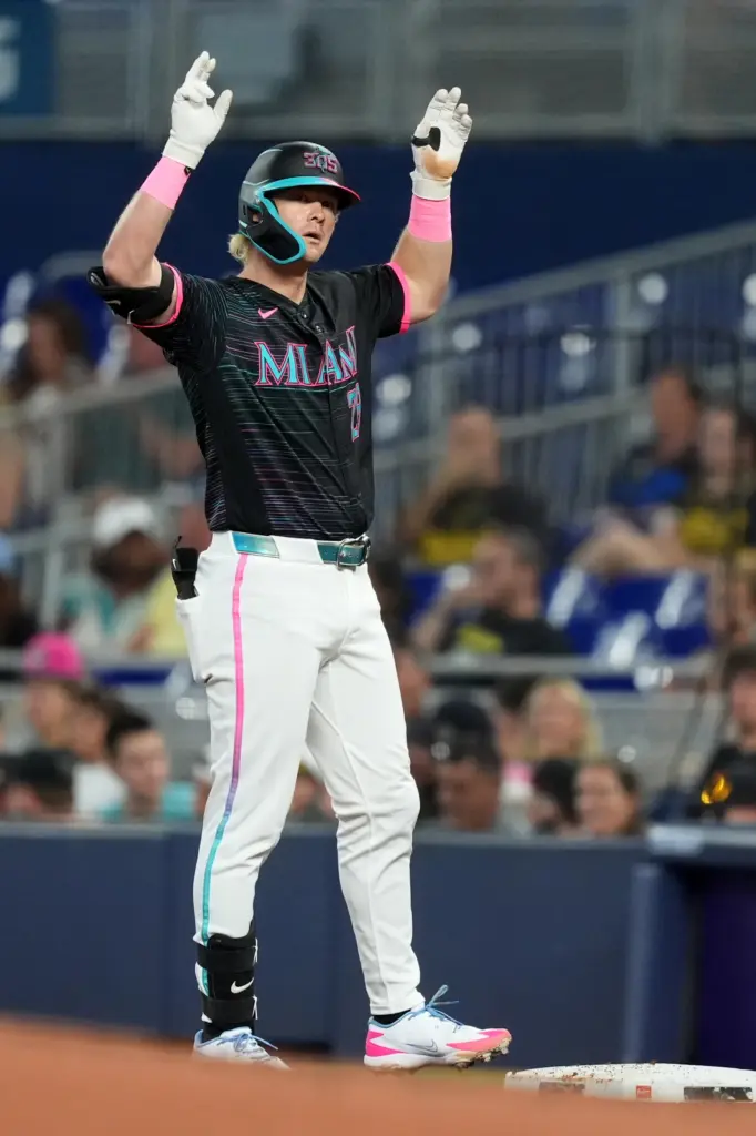 The Miami Marlins’ Kyle Stowers celebrates on first base after...
