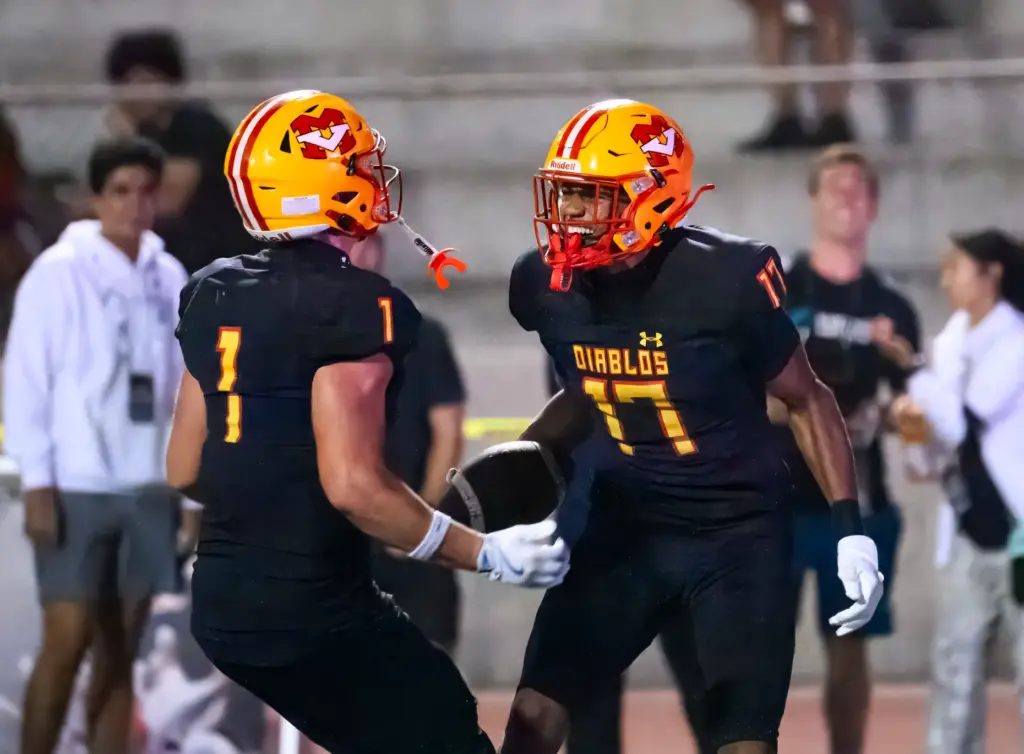 Mission Viejo wide receiver Jeremy Bonhomme, right, celebrates his touchdown...