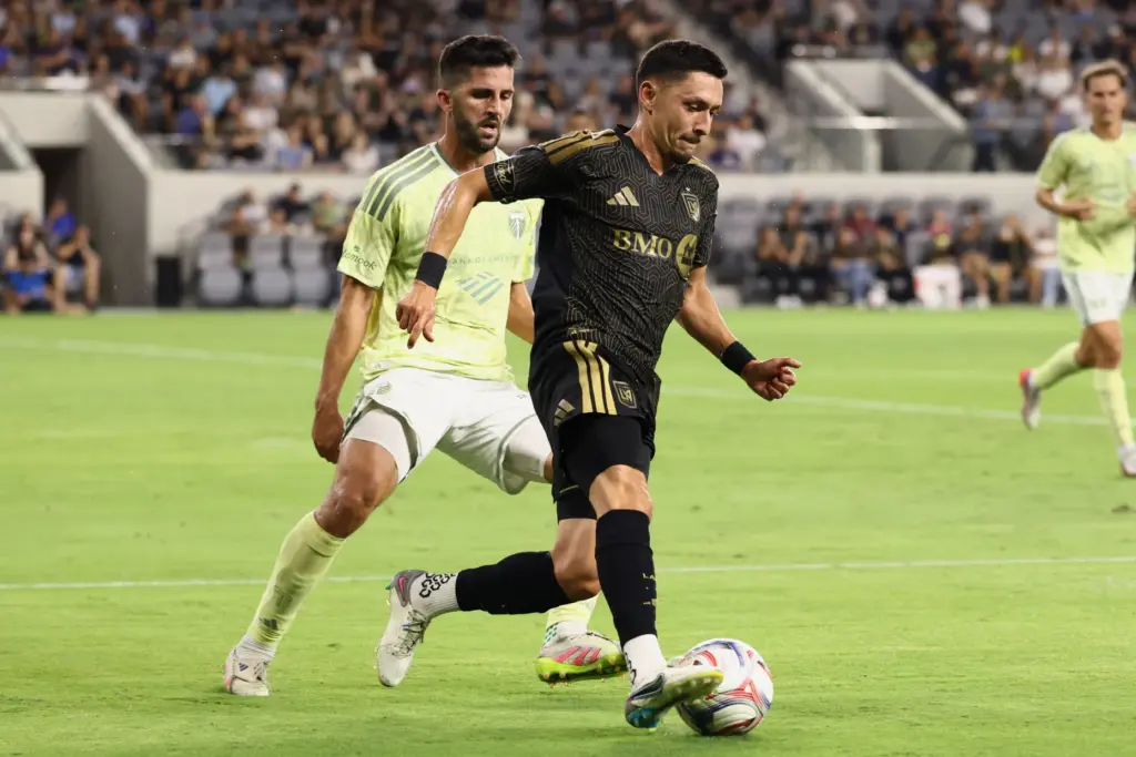 LAFC midfielder Mark Delgado, right, controls the ball against the...