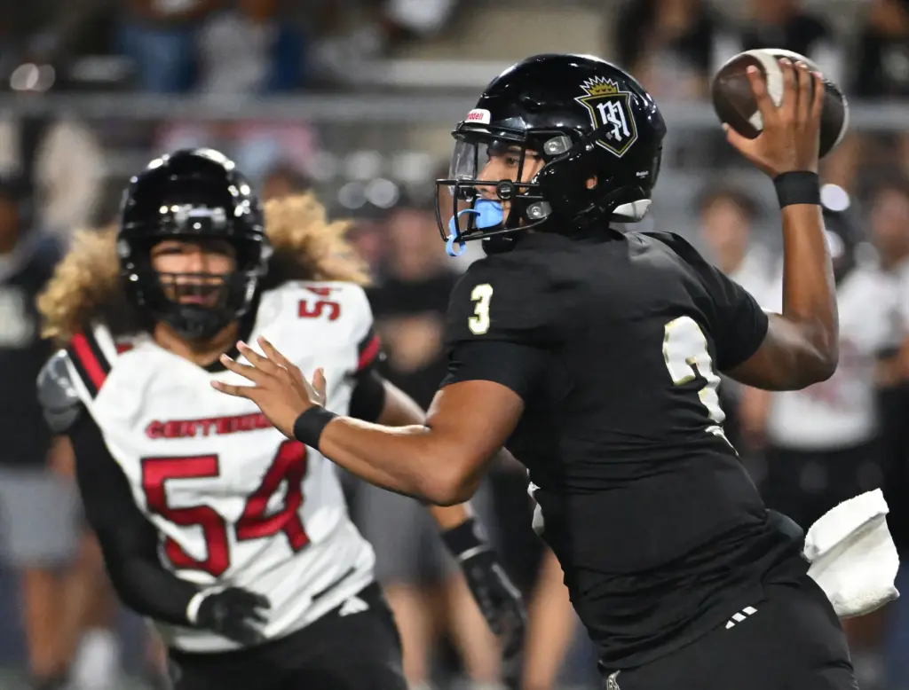 Serviteâs quarterback Gino Wang (3) completes a pass as Centennialâs...