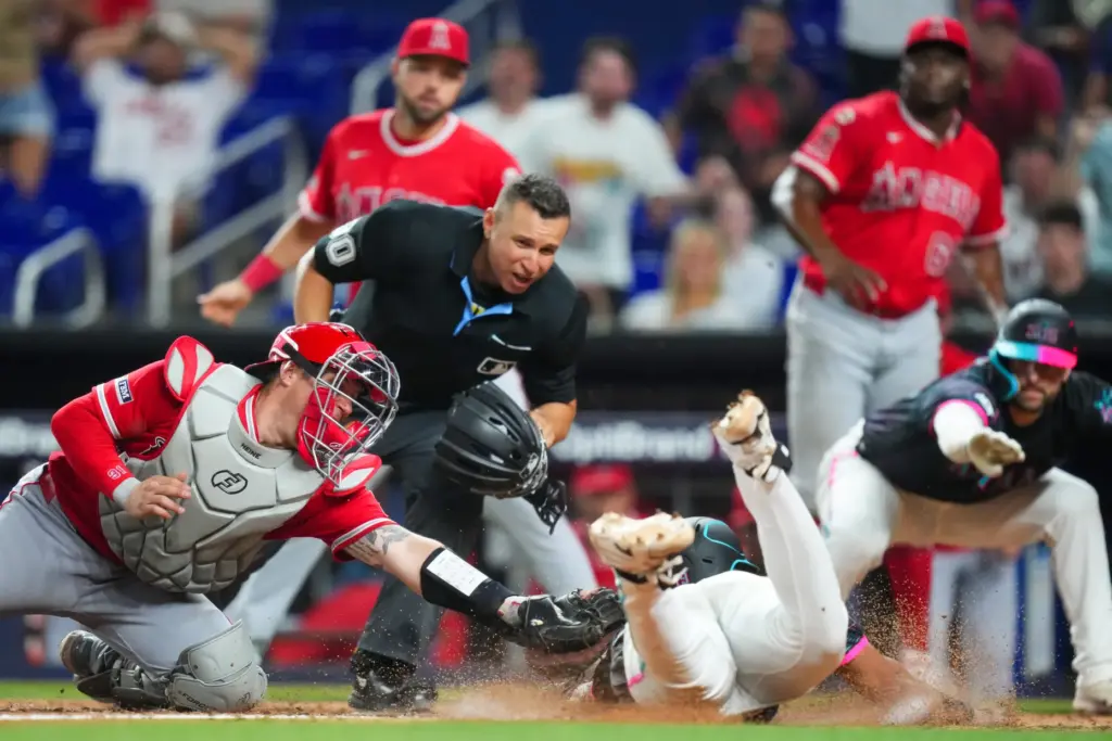 The Miami Marlins’ Leo Jimenez, right, is tagged out at...