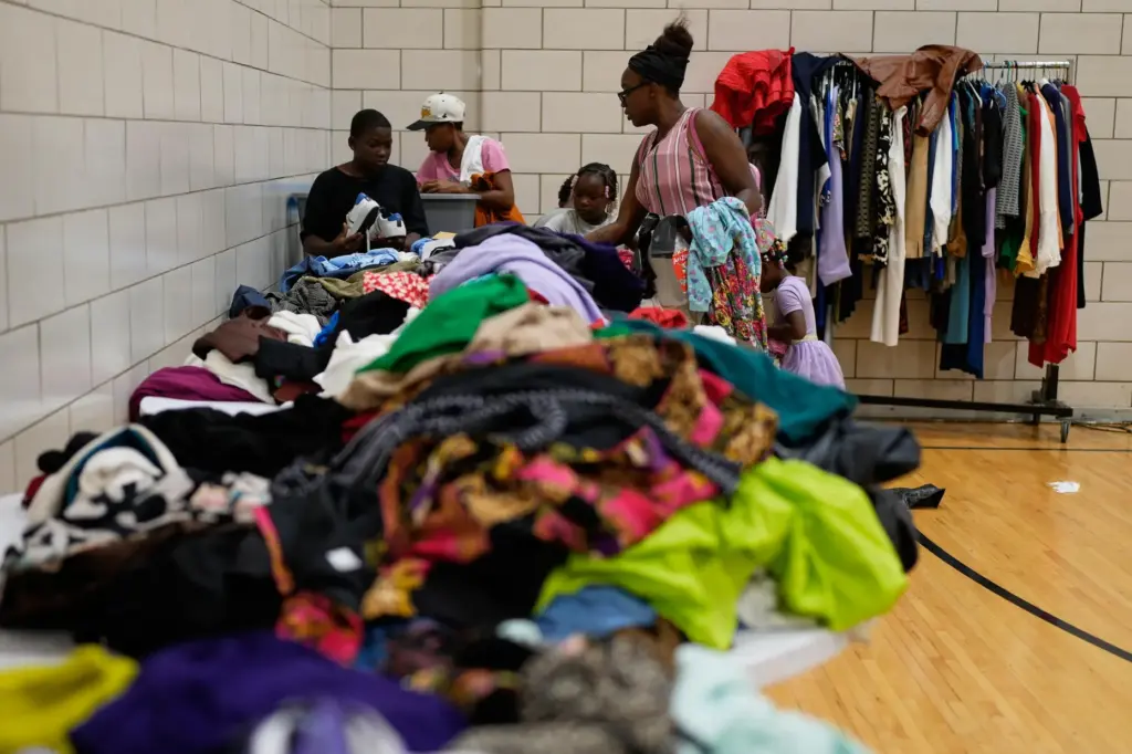 People look through donated clothes at City Life Center in...