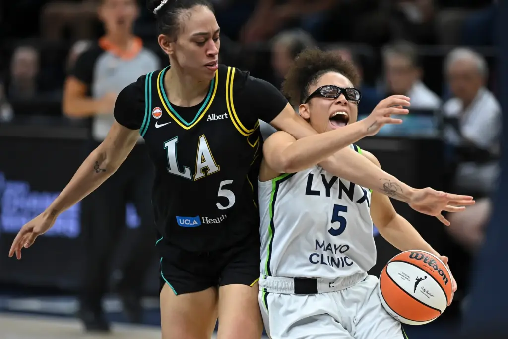 Minnesota Lynx guard Olivia Miles, right, is fouled by Sparks...