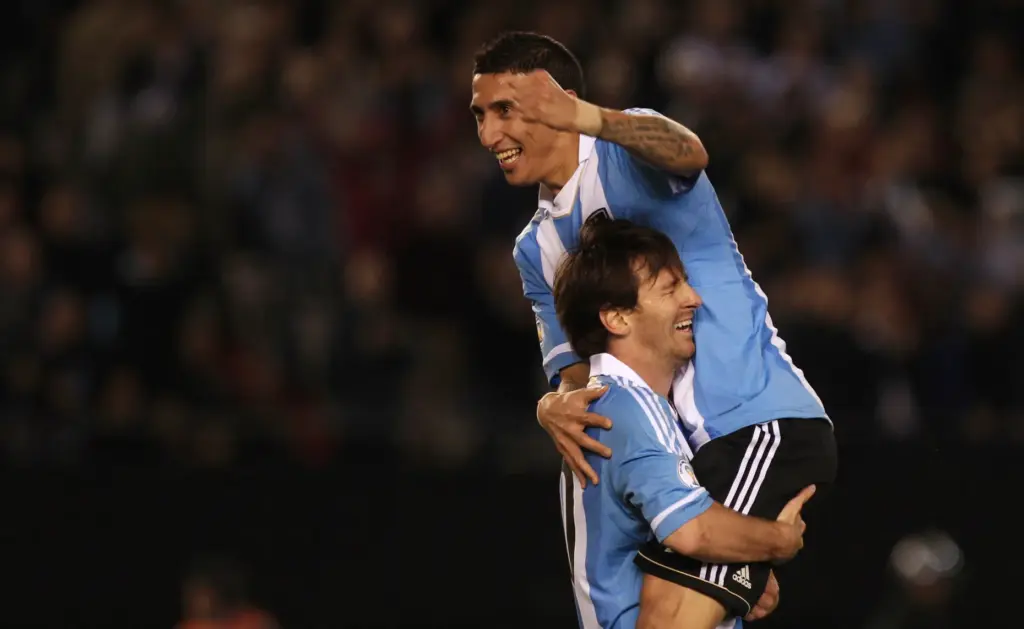 FILE – Argentina’s Angel Di Maria, top, celebrates with Argentina’s...