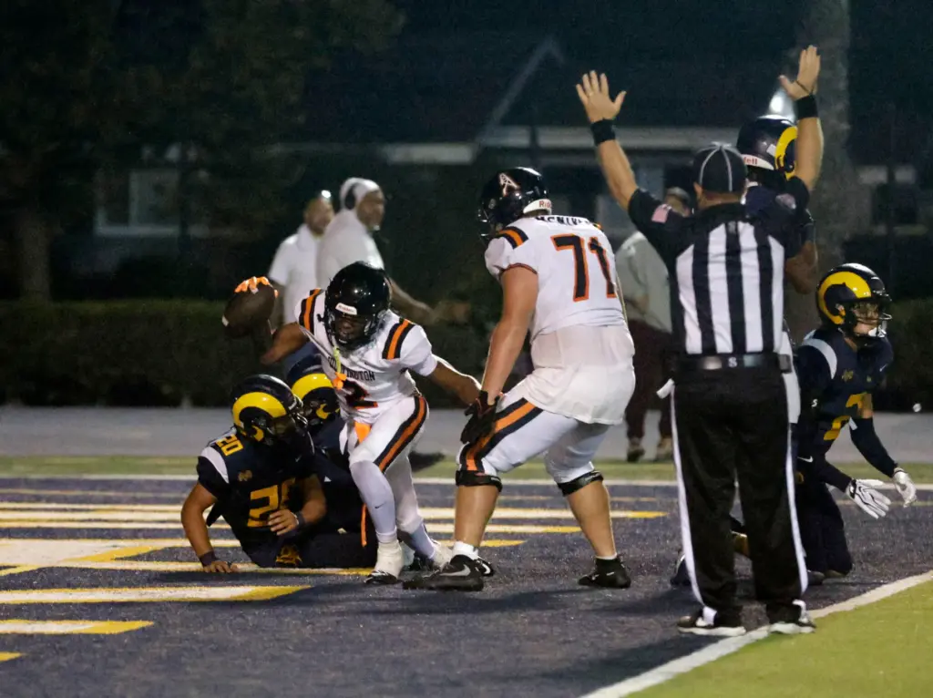 Huntington Beachs Dylan Bruce (2) scores as they take on...