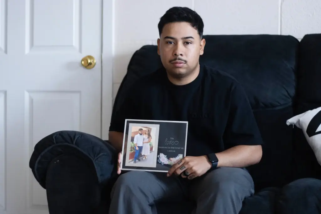Army Sgt. Hedar Leonel Turcios Juarez poses with a photo of his wife, Cristy.