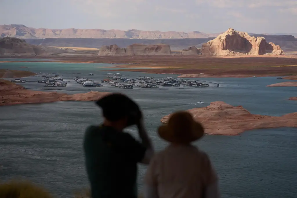 People stand on a lookout on Lake Powell at the Glen Canyon National Recreation Area.