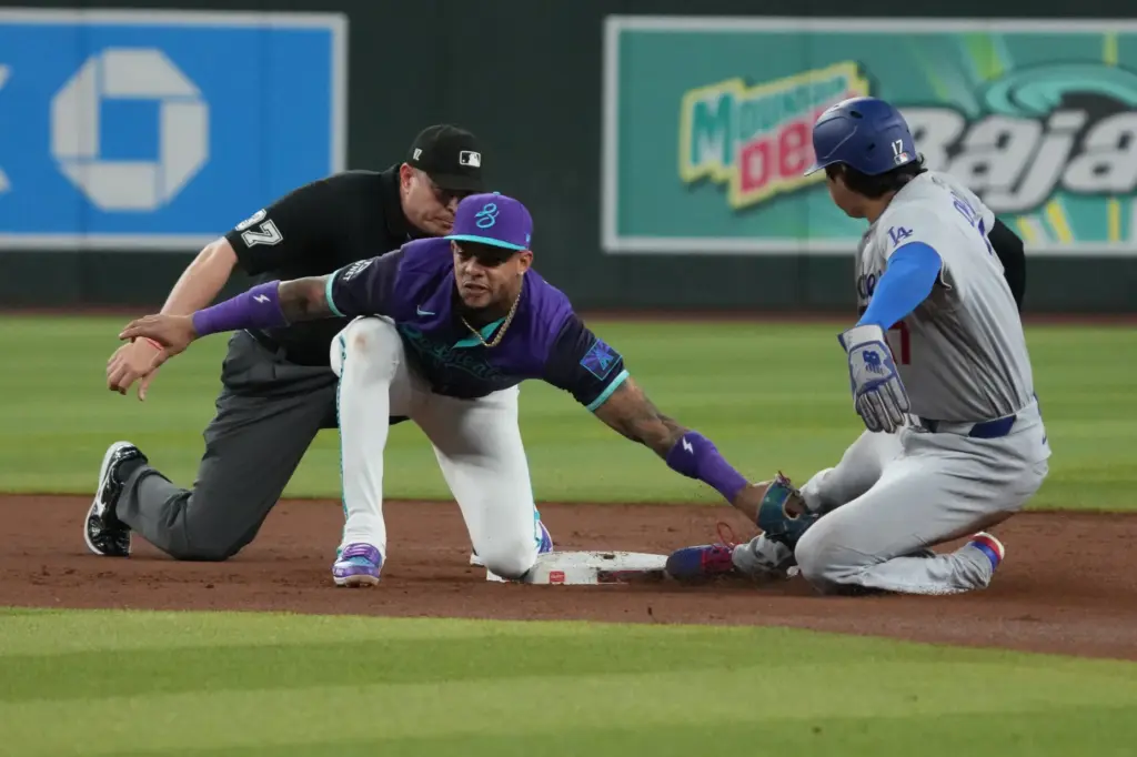 Arizona Diamondbacks second baseman Ketel Marte, front left, tags Dodgers...