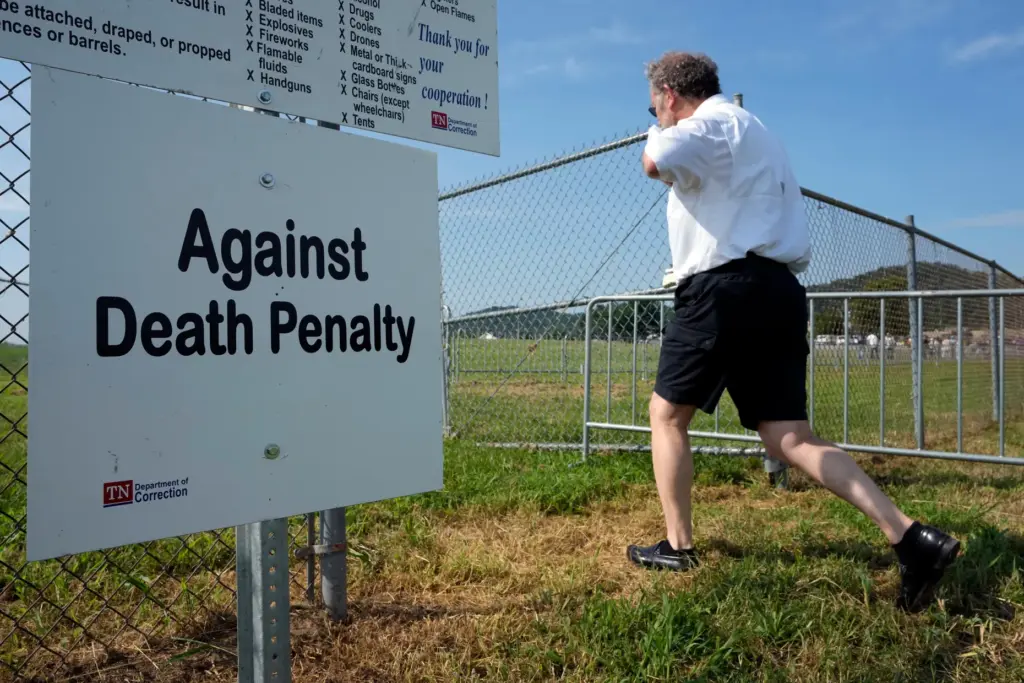 A man enters the area reserved for protesters opposed to the death penalty.