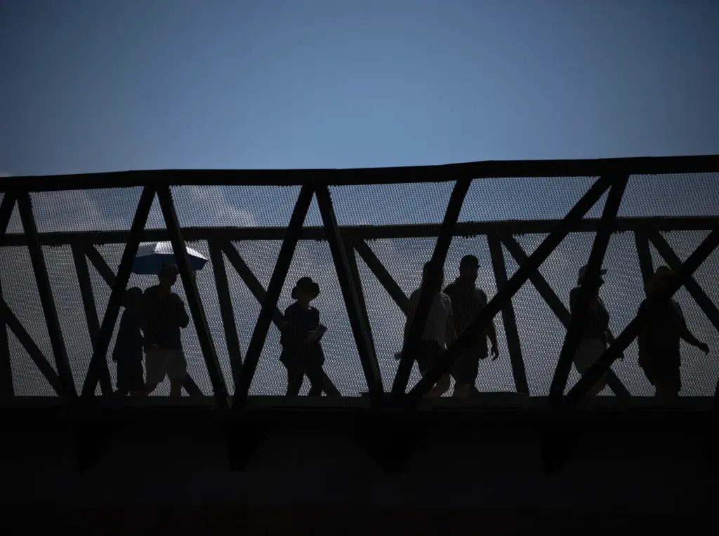 Pedestrians use the newly opened Jeffrey Open Space Trail bridge...
