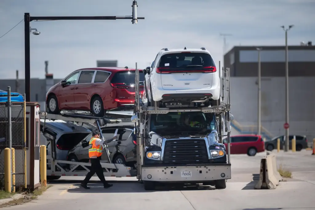 A transport truck carrying Chrysler Pacificas leaves the Windsor Assembly Plant.