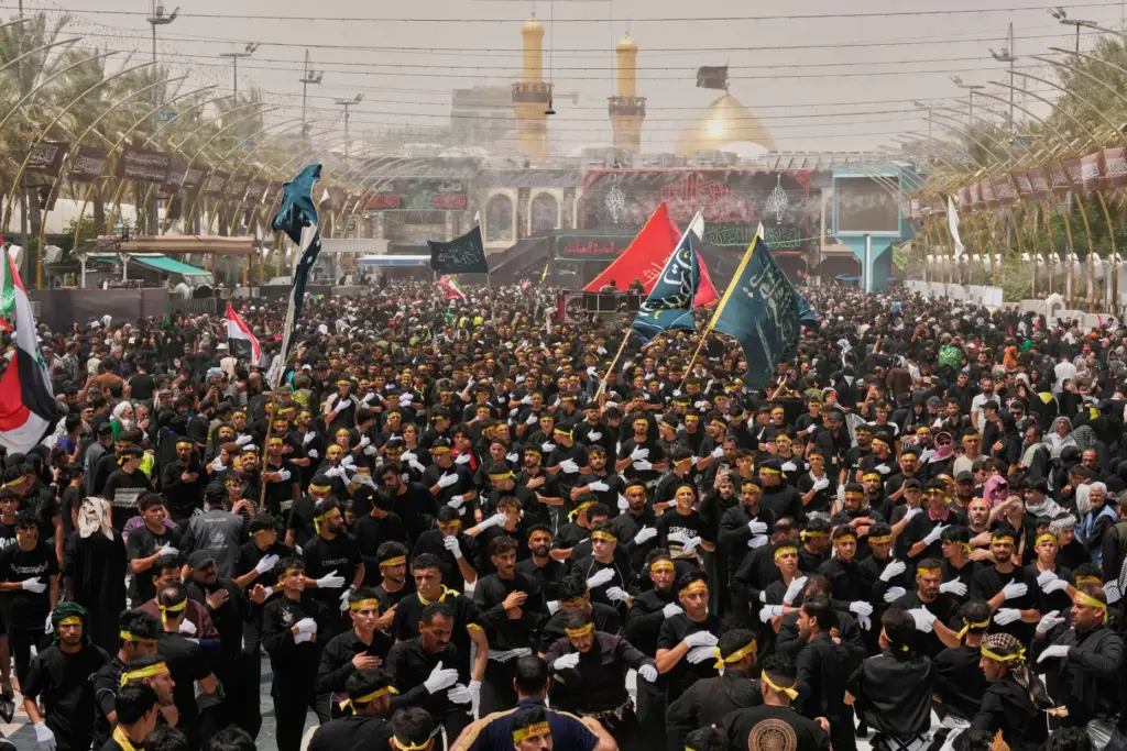 Shiite Muslim worshippers march toward the Imam Hussein Shrine.