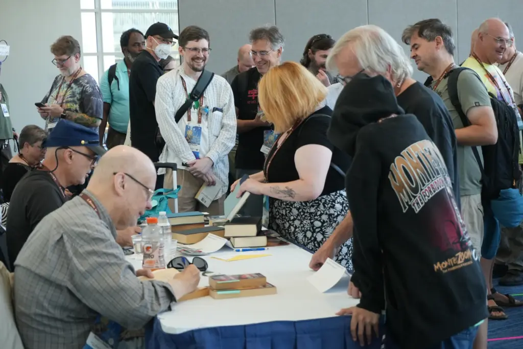 Dozens wait in line to get their books signed with...